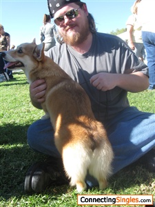 Holding a corgi for a trainer at a dog show