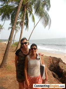 I'm the short one with short hair and an coral and beige skirt with one of the beaches near Kannur, India in the background.