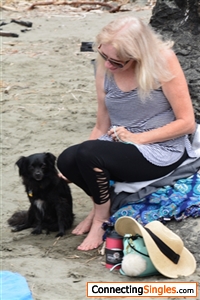 July 2017. At the beach why'd I even bother curling my hair?  This dog fell in love with me, he was so sweet.