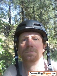 mountain biking in Washington state evergreen trees in back not smiling I just crashed
