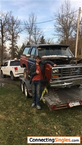 Older photo standing beside the old bronco when it was first brought home.