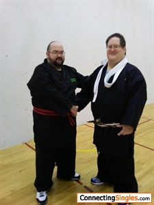 joe after receiving his latest belt in taekwondo from his instructor robert at the end of the adaptive taekwondo class representing the god's armour taekwono school