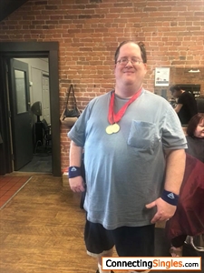 joe ray showing off the dals he won at special olympics state summer games a few years after competeing in horseshoes joe is at lamode the shop/salon where he gets his hair cut every 5 weeks al of the