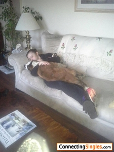 me with my cousin big dog ... he just wanted some love , that's why me and the dog are cuddling together up on the couch