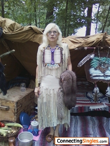 Full buckskins. I made the dress, bone breast plate and the painting hanging on side. The fur is silver fox. This was taken at one of our rendezvous camps. I belong to a mountain man club.