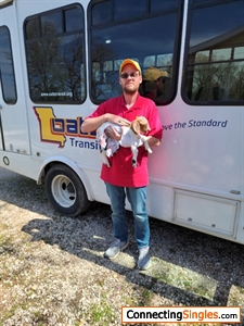 Me holding a goat next to my OATS Bus.