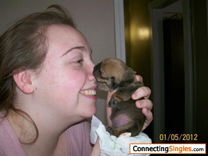 One of the puppies I fostered. She was about a week old in this picture, and I was kissing her tummy, she found my nose and latched on.