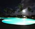 Pool lit with moon in the background Puzzle