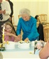 Aunty cutting cake you would think the Queen could have smiled