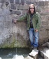 Me standing next to fountain in Cuzco Peru