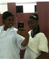 Me holding the phone with my daughter in the bathroom of my school I just completed a prom look for my hair assessment